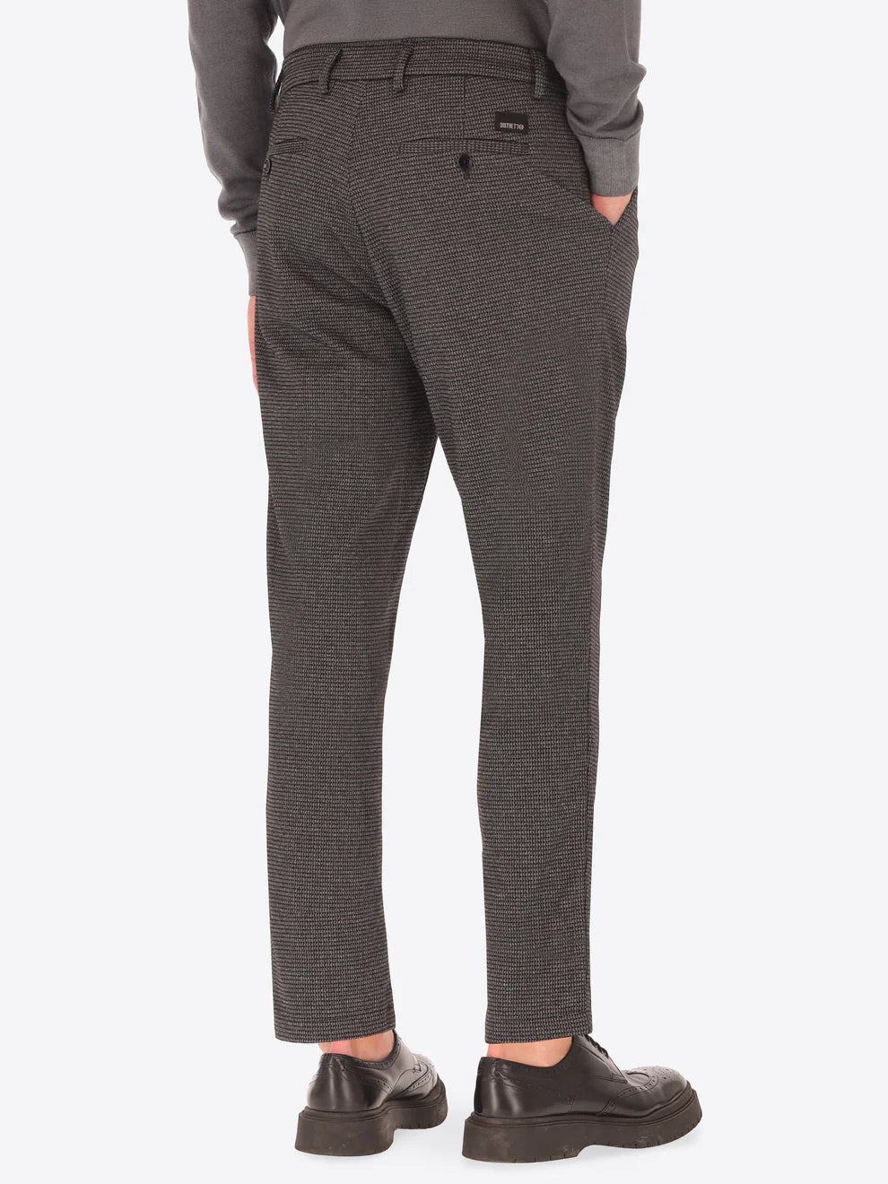 Grey Distretto12 trousers with micro check pattern on a male model facing away from camera