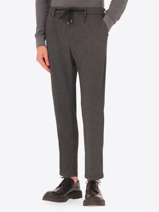 Grey Distretto12 trousers with micro check pattern on a male model