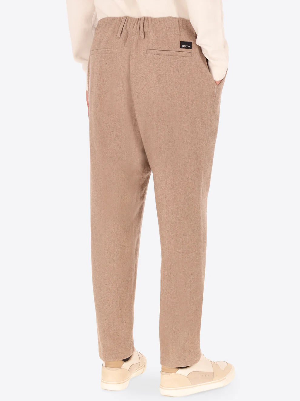 Beige Wool Blend Distretto12 trousers on a male model with his back turned