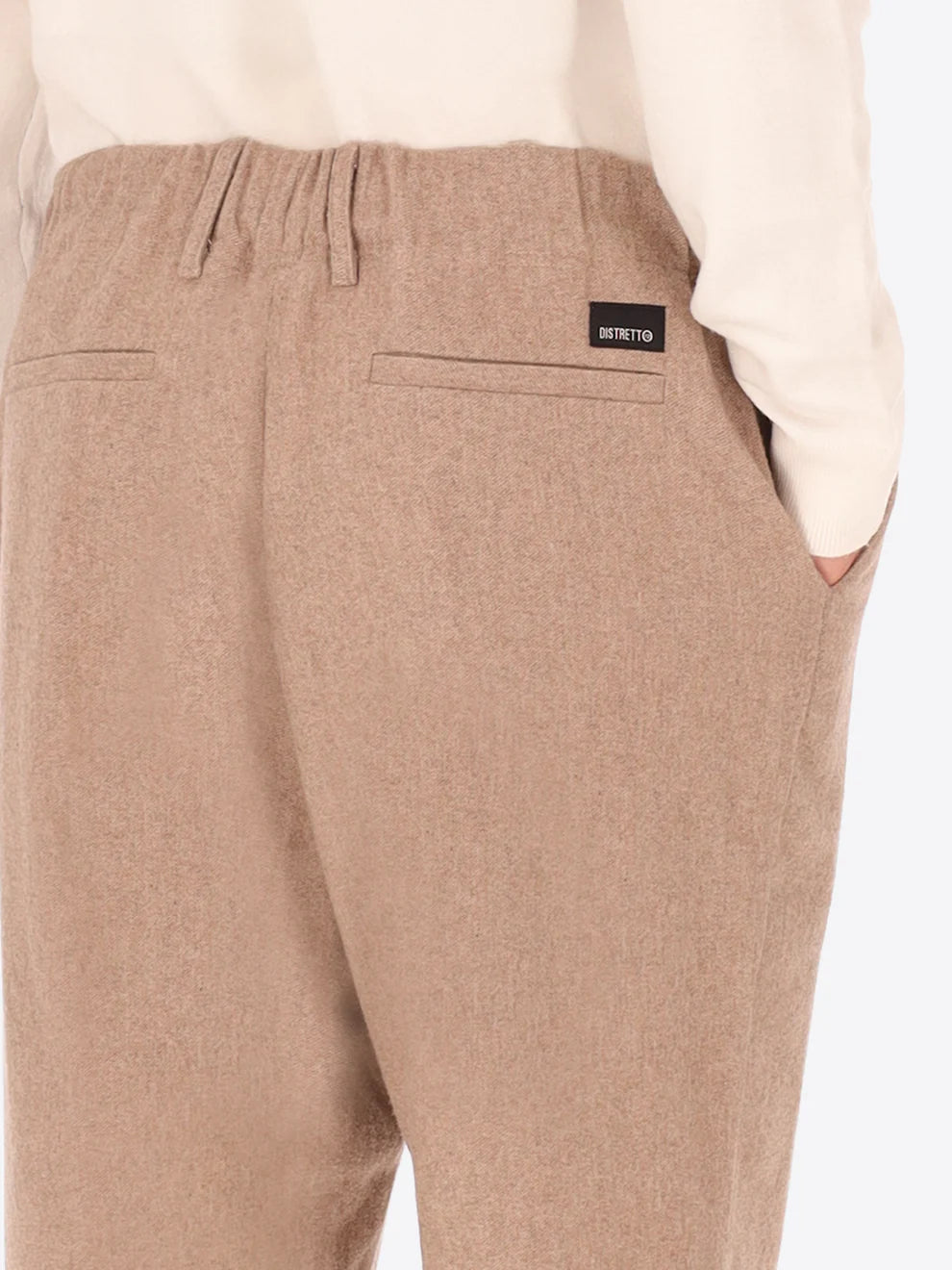Beige Wool Blend Distretto12 trousers on a male model with his back turned