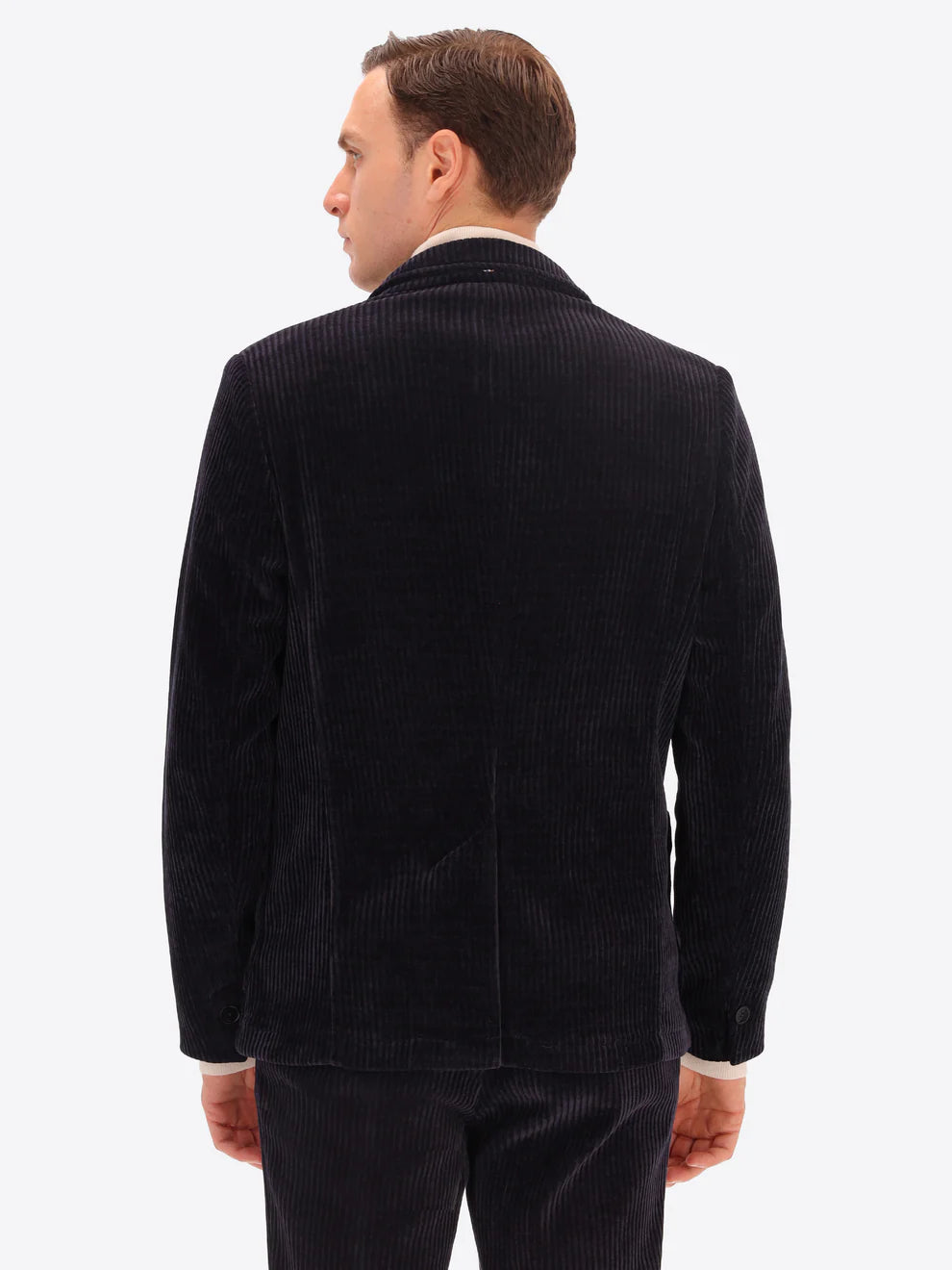 Male model wearing corduroy jacket by distretto12 in navy with back view