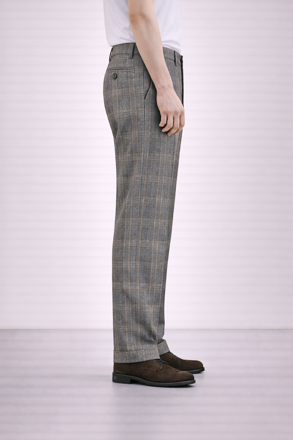 A side on image of a model wearing Germano 1952 grey trousers with check pattern.