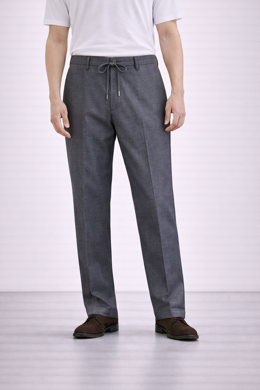 An image of a model wearing Germano 1952 grey drawstring trousers with pleat.