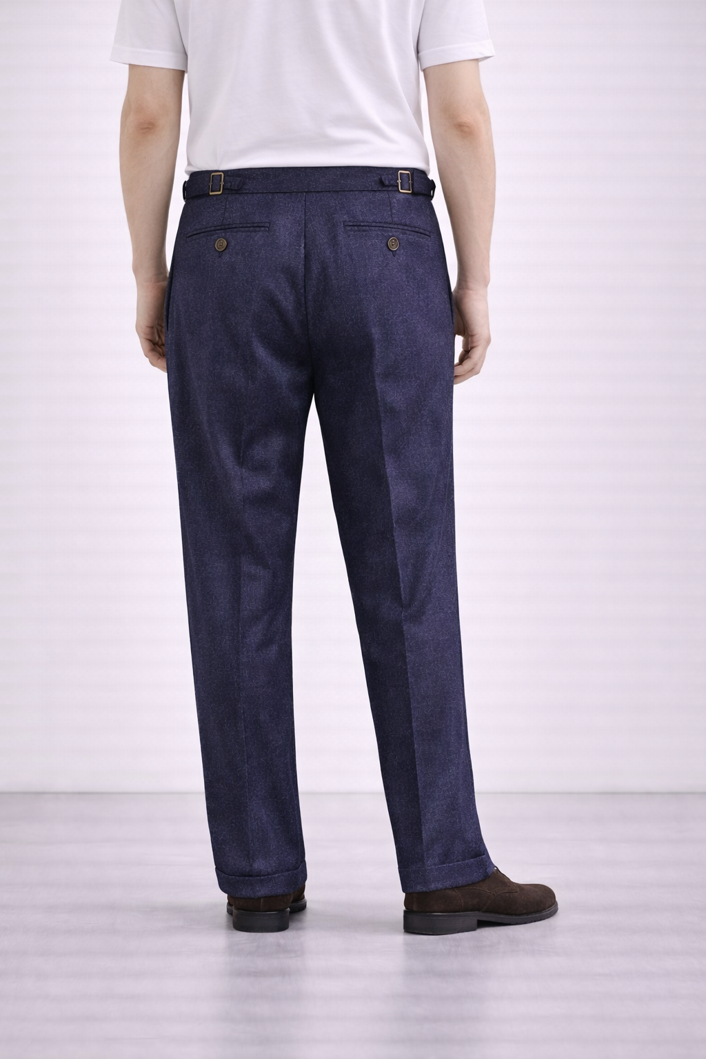 An image of a model wearing Germano 1952 blue trousers with a double pleat taken from the behind.