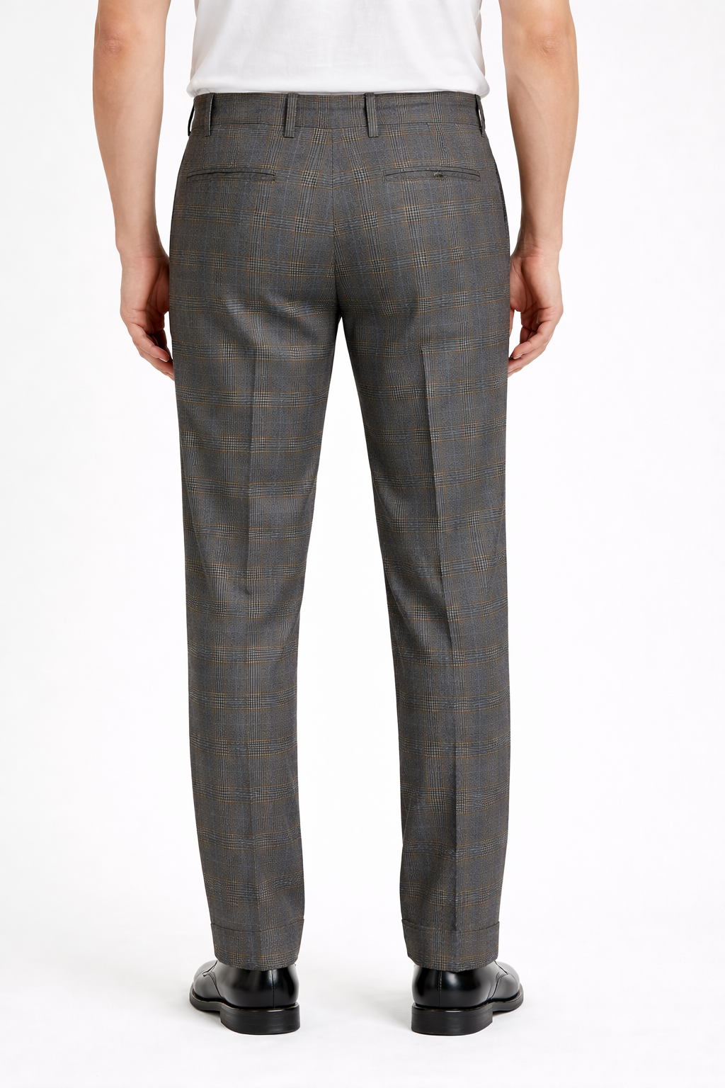 A back angled image of a model wearing Germano 1952 trousers with check containing blue & grey.