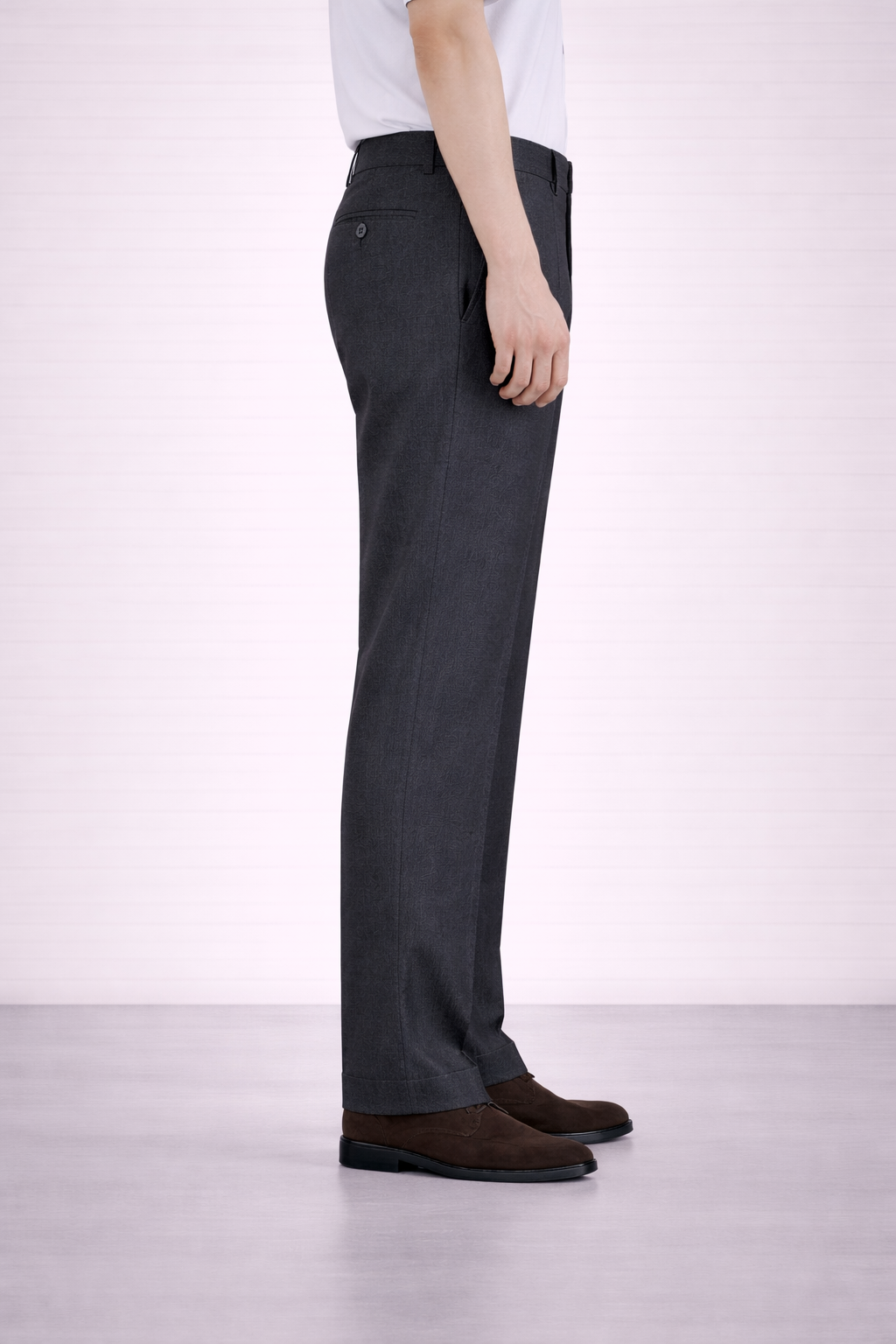 A side on image of a model wearing Germano 1952 charcoal trousers with slim fit and single pleat.