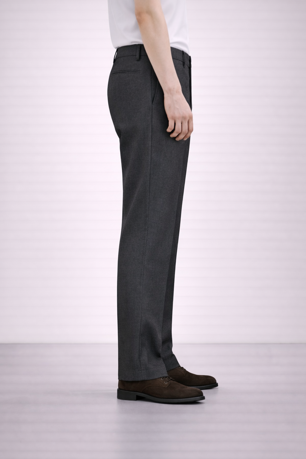 A side on image of a model wearing Germano 1952 charcoal trousers.