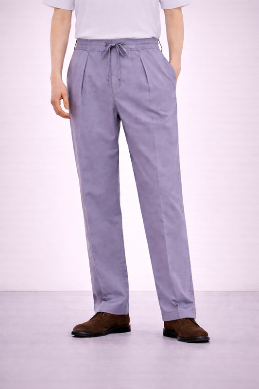 A model wearing Germano 1952 lilac drawstring trousers with single pleat. 