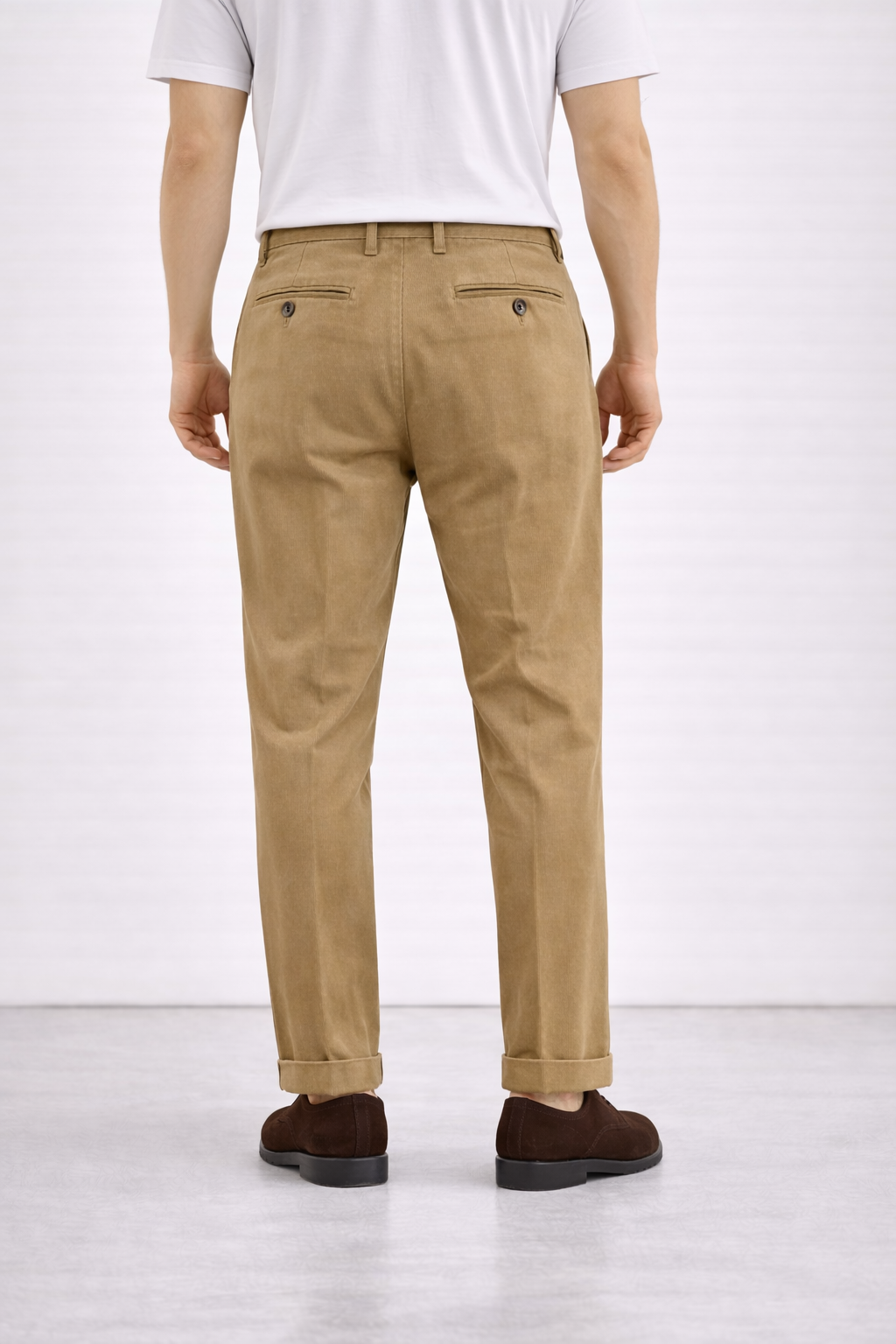 A back angled image of a model wearing Germano 1952 tan chinos.