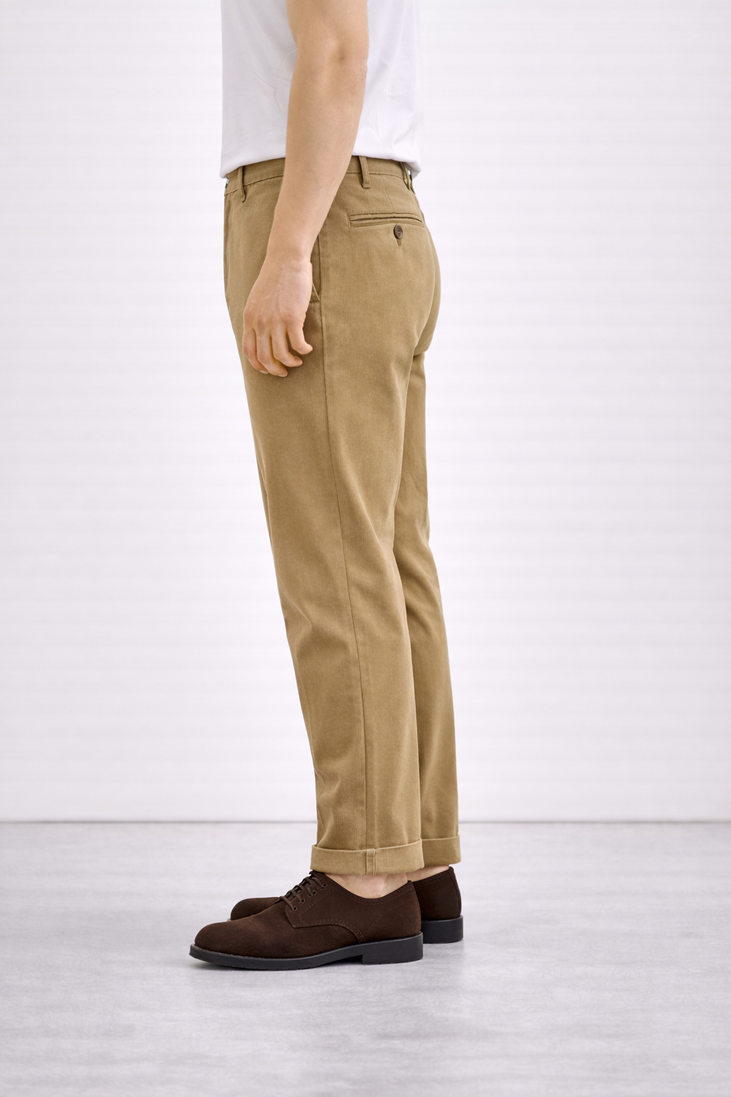 An image of a model wearing Germano 1952 tan chinos from behind.
