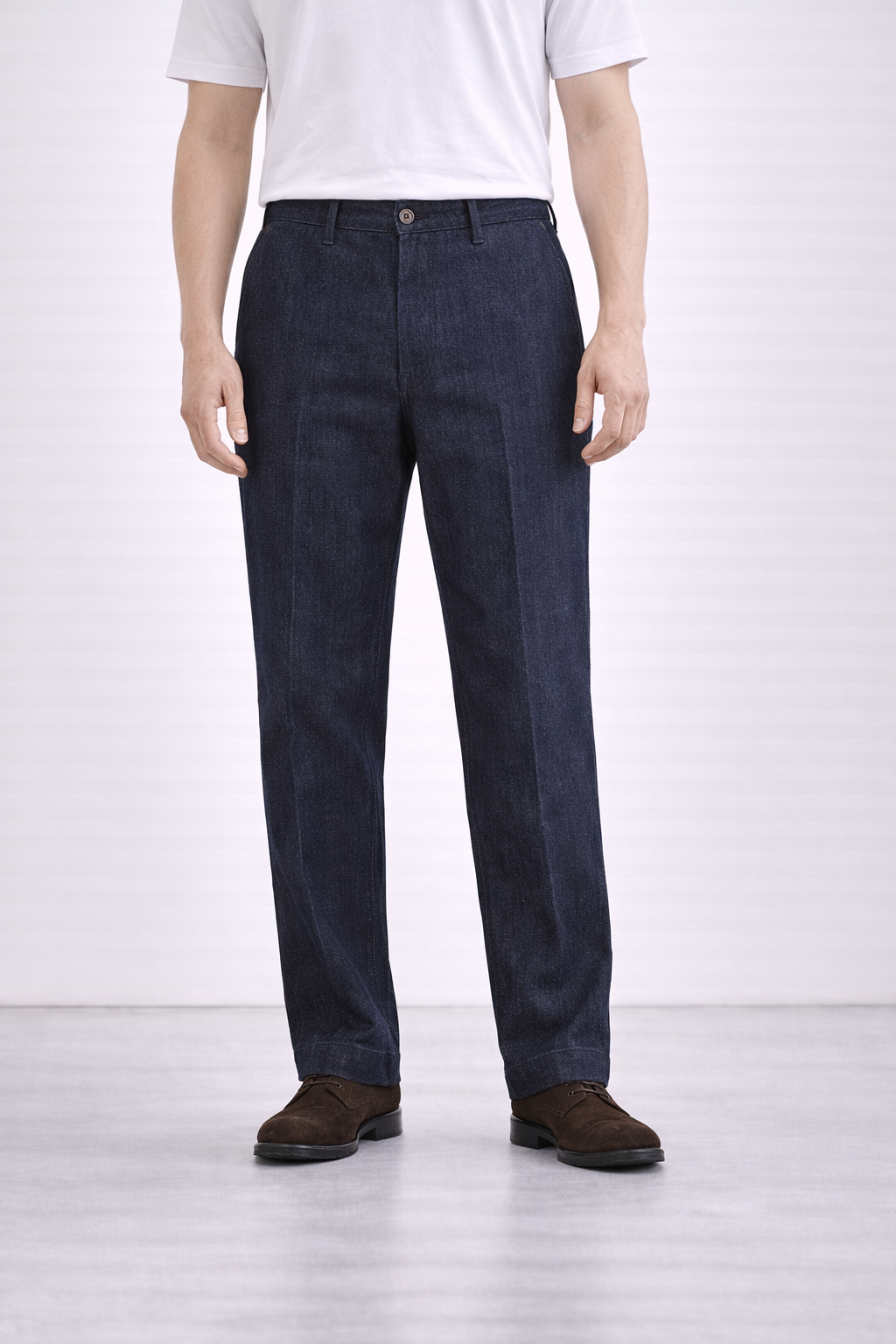 An image of a model wearing Germano 1952 denim trousers with a pleat.
