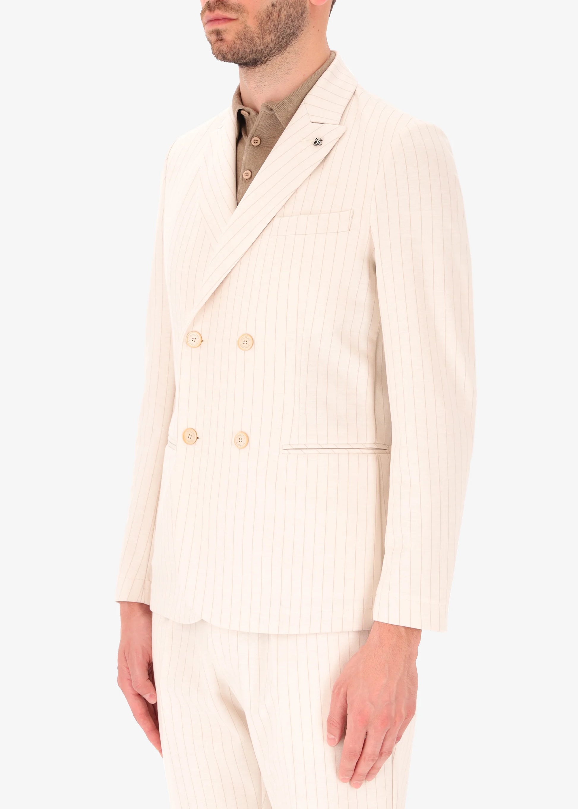 A side facing image of a model wearing Distretto 12 Double Breasted Jacket Luci in cream.
