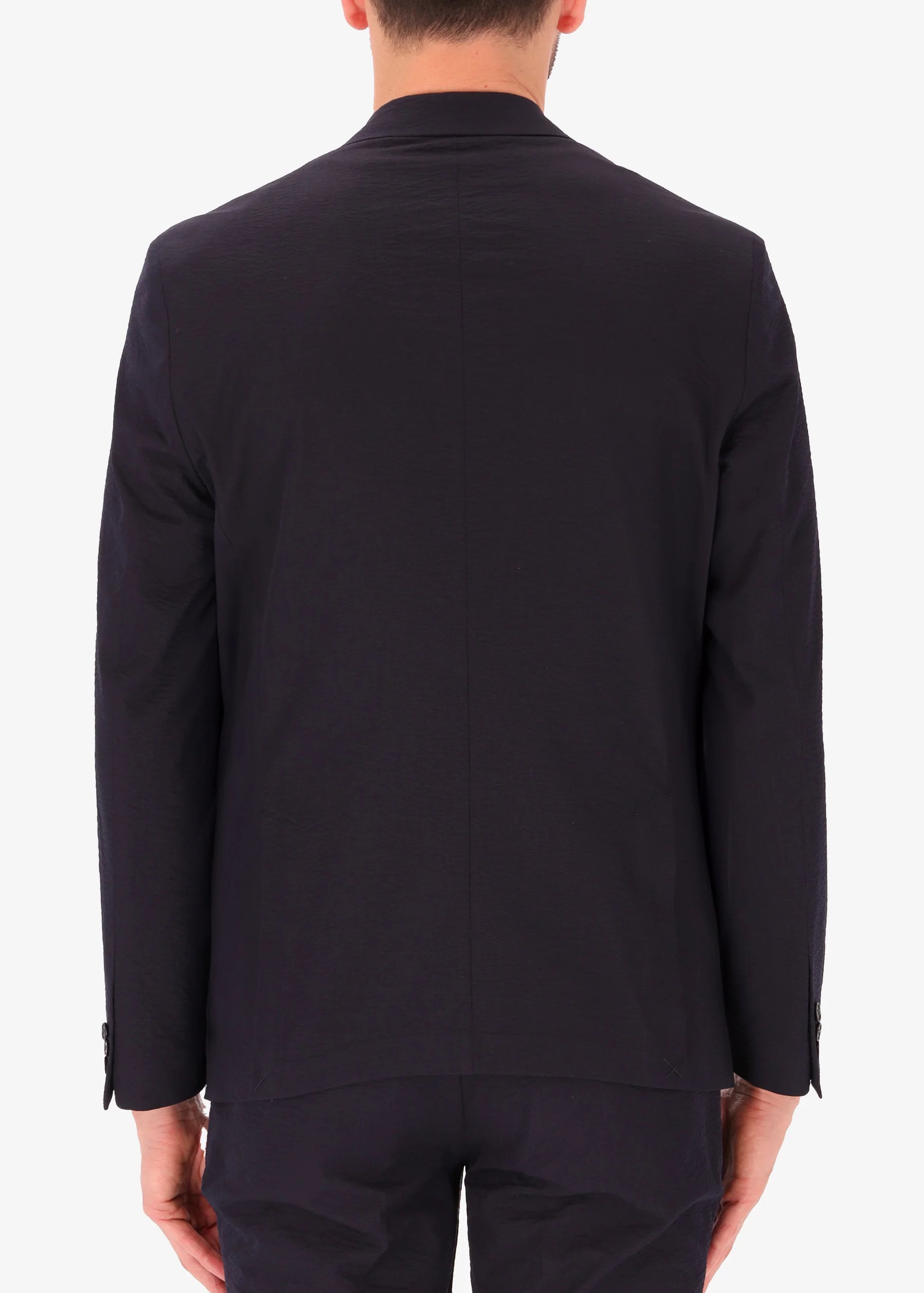 A back facing image of a model wearing Distretto 12 Tailoring tech  Double Breasted Jacket Arezzo.