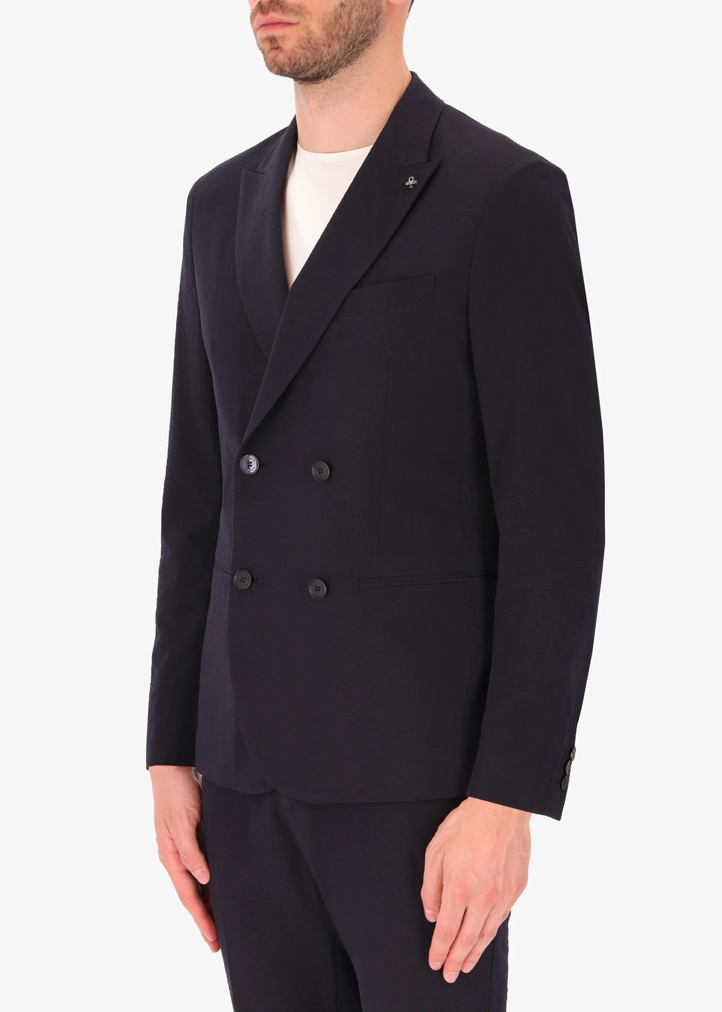 A side facing image of a model wearing Distretto 12 Tailoring tech  Double Breasted Jacket Arezzo.