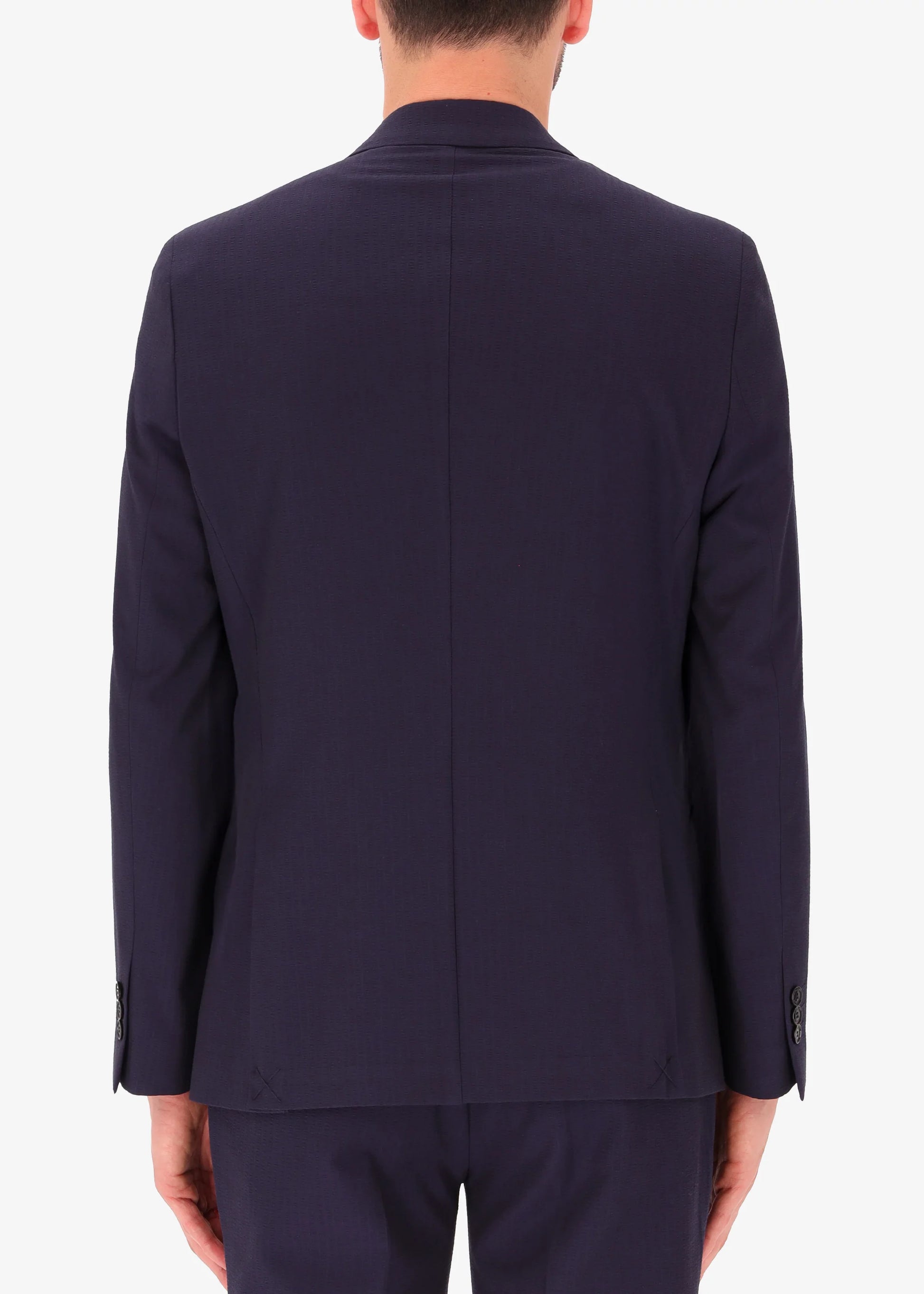 A back facing image of a model wearing Distretto 12 Double BreastedTailoring tech Firenze Jacket.