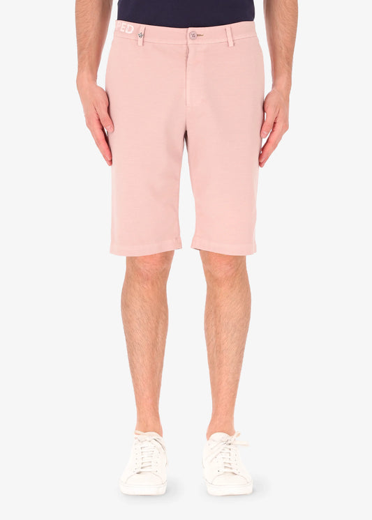 An image of a model wearing shorts in pink from Distretto 12.