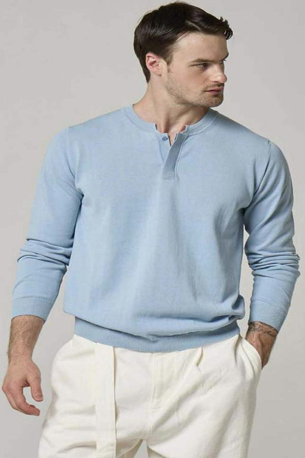 An image of a model wearing a Wool&Co, sky blue cardigan.