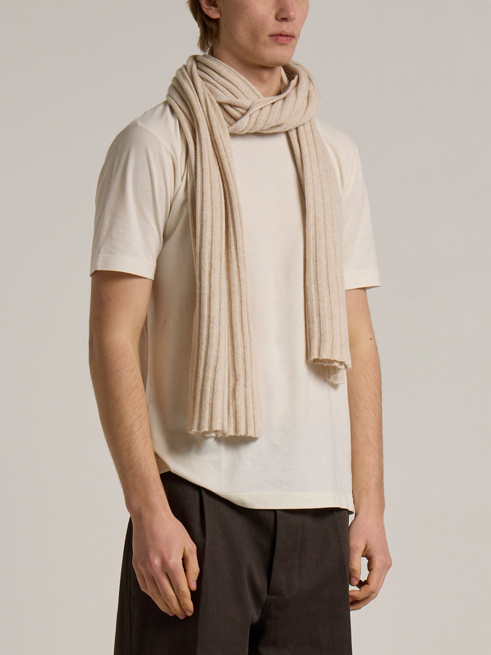 A model wearing a Wool&Co Lambswool blend scarf in cream colour.