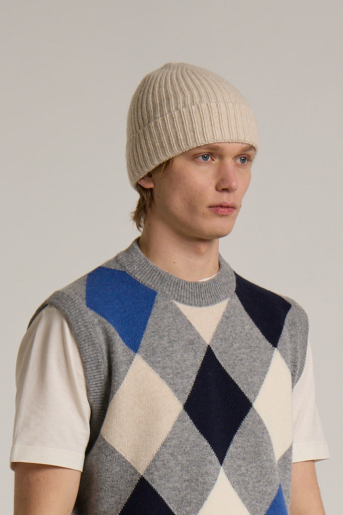 A model wearing a Wool&Co Merino wool blend beanie hat in cream colour.