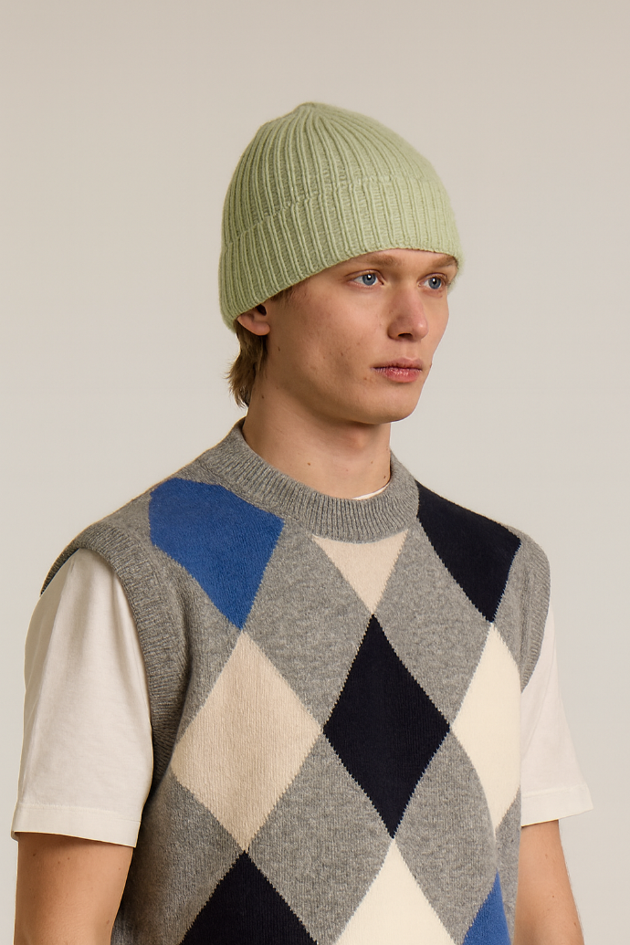 A model wearing a Wool&Co Merino wool blend beanie hat in light green.