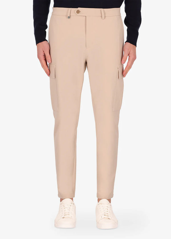 An image of a model wearing Distretto12 cargo newman trousers in cream.