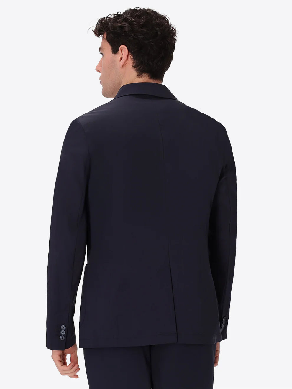 A man wearing Distretto 12 Jacket grano in navy from behind